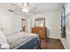 Bedroom with wood floors, large dresser, and natural light from the nearby window at 4108 Woodtrail Blvd, New Port Richey, FL 34653