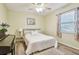 Bedroom with bright yellow walls, a piano, a bed and natural light coming from the window at 4108 Woodtrail Blvd, New Port Richey, FL 34653