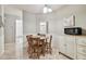 Inviting dining area with table and adjacent storage at 4108 Woodtrail Blvd, New Port Richey, FL 34653
