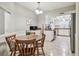Charming dining area adjacent to the kitchen with chandelier lighting at 4108 Woodtrail Blvd, New Port Richey, FL 34653