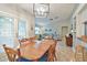 Dining room connecting to the living area, filled with natural light and a cozy ambiance at 4108 Woodtrail Blvd, New Port Richey, FL 34653