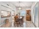 Inviting dining area with a wooden table, chairs, and access to the kitchen and backyard at 4108 Woodtrail Blvd, New Port Richey, FL 34653