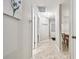 Neutral hallway featuring tile flooring and access to multiple rooms at 4108 Woodtrail Blvd, New Port Richey, FL 34653