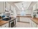 Updated kitchen with stainless steel appliances, wood countertops, and bright lighting at 4108 Woodtrail Blvd, New Port Richey, FL 34653