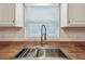 Modern kitchen sink with stainless steel faucet and white backsplash at 4108 Woodtrail Blvd, New Port Richey, FL 34653