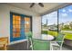 Comfortable screened lanai with table, chairs and views of the neighborhood at 4108 Woodtrail Blvd, New Port Richey, FL 34653