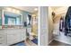 Recently renovated bathroom and a walk-in closet with modern fixtures and ample storage space at 4207 Northwind Ln, Tampa, FL 33624