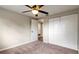 A clean bedroom showcasing a ceiling fan, spacious closet, and a doorway to the next room at 4207 Northwind Ln, Tampa, FL 33624
