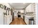 Bright kitchen featuring white cabinetry, mosaic backsplash, and modern appliances at 4207 Northwind Ln, Tampa, FL 33624