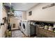 Convenient laundry room with modern washer and dryer, shelving, and a storage area at 4207 Northwind Ln, Tampa, FL 33624