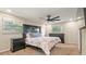 Comfortable bedroom featuring carpet, a large bed, dual windows, and dark furniture at 4207 Northwind Ln, Tampa, FL 33624