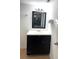 Bathroom vanity in black color with a dark framed mirror at 4207 Winding Moss Trl # 201, Tampa, FL 33613