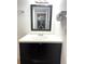 Bathroom vanity featuring a white countertop, black cabinet, and framed mirror at 4207 Winding Moss Trl # 201, Tampa, FL 33613