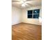 Bedroom with wood-look floors, a ceiling fan, and a bright window view at 4207 Winding Moss Trl # 201, Tampa, FL 33613