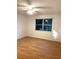 Bedroom with wood-look floors, a ceiling fan, and a window view at 4207 Winding Moss Trl # 201, Tampa, FL 33613