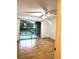 Bright bedroom with a sliding glass door to balcony and wood-look flooring at 4207 Winding Moss Trl # 201, Tampa, FL 33613