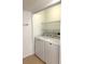 Laundry room featuring a white washer and dryer, and wire shelving at 4207 Winding Moss Trl # 201, Tampa, FL 33613