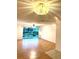 Open living area with laminate flooring and sliding door access to balcony at 4207 Winding Moss Trl # 201, Tampa, FL 33613