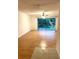 Living room with wood-look floors and sliding glass doors to a balcony at 4207 Winding Moss Trl # 201, Tampa, FL 33613