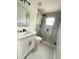 Modern bathroom with glass-enclosed shower, new fixtures, marble accents, and sleek vanity at 4415 Tuna Dr, Tampa, FL 33617