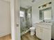 Bright, modern bathroom with glass shower, new fixtures, marble accents, and sleek vanity at 4415 Tuna Dr, Tampa, FL 33617
