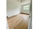 Clean bedroom highlighting hardwood floors, neutral walls, and a window at 4415 Tuna Dr, Tampa, FL 33617
