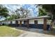 Charming single-story home featuring a new driveway, fresh paint, and new brick facade and wood porch columns at 4415 Tuna Dr, Tampa, FL 33617