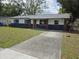 Charming single-story home featuring a freshly painted exterior and mature trees at 4415 Tuna Dr, Tampa, FL 33617