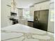 This open-concept kitchen features modern appliances and quartz countertops, with ample natural light at 4415 Tuna Dr, Tampa, FL 33617