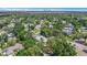 An aerial view of the home in a treed neighborhood, showing proximity to a distant city at 4925 Alcazar S Way, St Petersburg, FL 33712