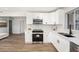 Modern kitchen boasts white cabinets, stainless steel appliances, elegant countertops, and seamless access to adjacent living areas at 4925 Alcazar S Way, St Petersburg, FL 33712