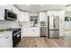 Modern kitchen features stainless steel appliances, white cabinets, and beautiful countertops at 4925 Alcazar S Way, St Petersburg, FL 33712