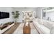 Open-concept living area with hardwood floors, ample seating, and stylish decor seamlessly connecting to the kitchen at 4925 Alcazar S Way, St Petersburg, FL 33712