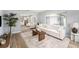 Cozy living room featuring a comfortable sofa, stylish decor, hardwood flooring, and plenty of natural light at 4925 Alcazar S Way, St Petersburg, FL 33712