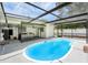 Inviting pool area featuring ample seating, screened enclosure, and access to the outdoor kitchen at 4925 Alcazar S Way, St Petersburg, FL 33712