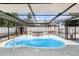 Inviting in-ground pool with screened enclosure, surrounded by a deck and a separate hot tub at 4925 Alcazar S Way, St Petersburg, FL 33712