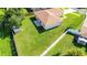 Aerial shot of a lush backyard, with a well-maintained lawn and white privacy fence at 4928 Timber Way, Zephyrhills, FL 33542