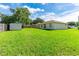 Lush backyard featuring a sturdy storage shed, providing ample space for recreation at 4928 Timber Way, Zephyrhills, FL 33542