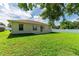 Well-maintained backyard featuring a lush green lawn, slider access, and a white vinyl privacy fence at 4928 Timber Way, Zephyrhills, FL 33542