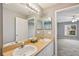 Bright bathroom with double sinks and neutral features connecting to the bedroom at 4928 Timber Way, Zephyrhills, FL 33542