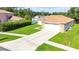 Charming home with manicured front lawn and a long driveway leading to a two-car garage at 4928 Timber Way, Zephyrhills, FL 33542