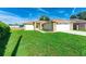 Single-story home with a well-maintained lawn and a two-car garage at 4928 Timber Way, Zephyrhills, FL 33542