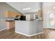 Well-lit kitchen with breakfast bar, wood cabinets and stainless steel appliances at 4928 Timber Way, Zephyrhills, FL 33542