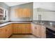 Updated kitchen featuring wood cabinets, modern countertops, and stainless steel sink at 4928 Timber Way, Zephyrhills, FL 33542