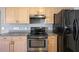 Well-equipped kitchen featuring stainless steel appliances and ample cabinet space at 4928 Timber Way, Zephyrhills, FL 33542