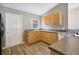 Bright kitchen featuring wood cabinets, modern countertops, and stainless steel sink at 4928 Timber Way, Zephyrhills, FL 33542