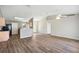 Spacious living room features hardwood floors, ceiling fan, and a view into the kitchen at 4928 Timber Way, Zephyrhills, FL 33542
