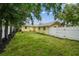 Spacious backyard with a white privacy fence and green grass at 508 38Th N Ave, St Petersburg, FL 33704