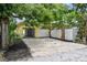 Bright home with open garage and white gravel driveway surrounded by mature trees and landscaping at 508 38Th N Ave, St Petersburg, FL 33704