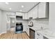 Modern kitchen with stainless steel appliances, bright white cabinetry, and modern countertops at 508 38Th N Ave, St Petersburg, FL 33704